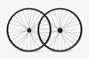 Two bicycle wheels on a white background